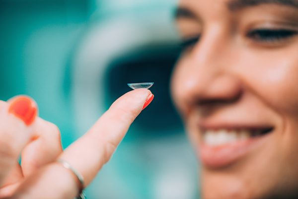 Ophthalmologist inserting soft contact lens